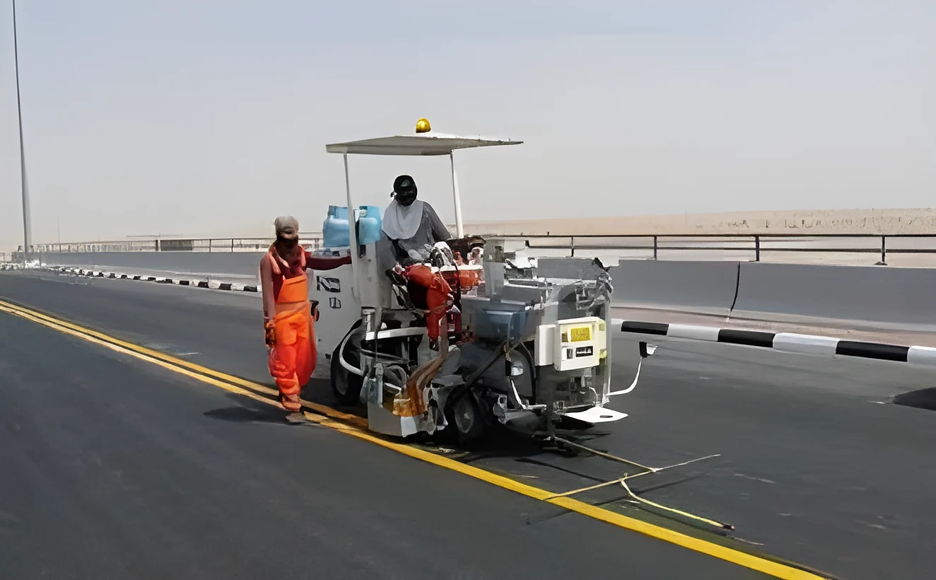 Road marking crew on a new asphalt carriageway